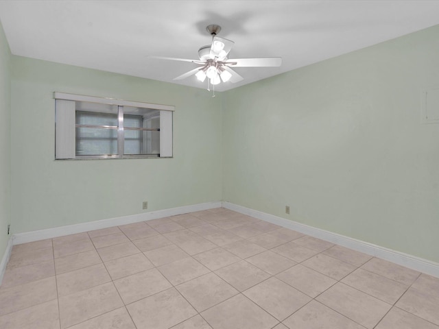 tiled spare room with ceiling fan