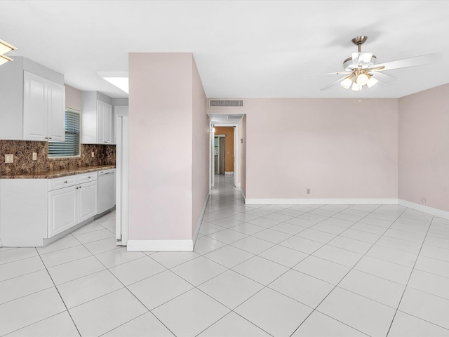 tiled empty room featuring ceiling fan