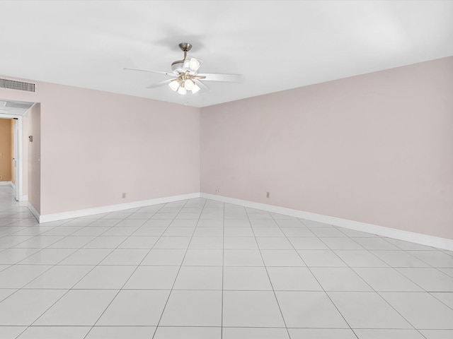 tiled empty room featuring ceiling fan