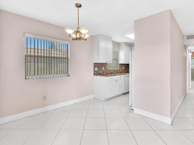 kitchen with white cabinetry, dishwasher, an inviting chandelier, tasteful backsplash, and decorative light fixtures