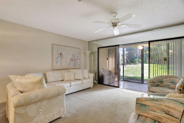 carpeted living room featuring ceiling fan and a textured ceiling