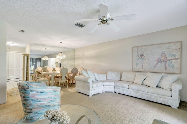 carpeted living room with a textured ceiling, vaulted ceiling, and ceiling fan