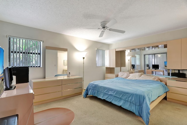 carpeted bedroom with a textured ceiling and ceiling fan