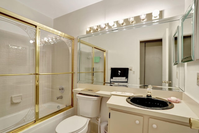 full bathroom featuring vanity, toilet, and shower / bath combination with glass door