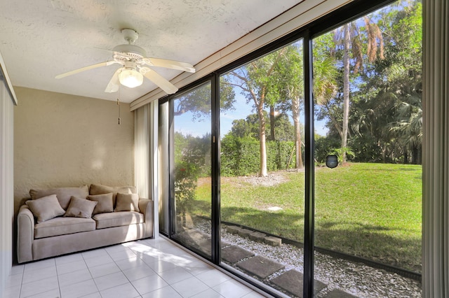 unfurnished sunroom with ceiling fan