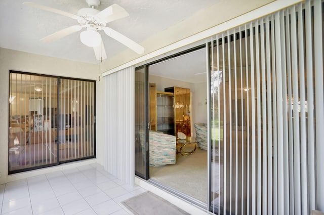 unfurnished sunroom with ceiling fan