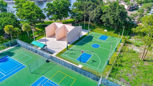 view of sport court featuring a water view and tennis court