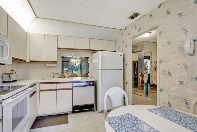 kitchen with white appliances, white cabinets, sink, a textured ceiling, and tasteful backsplash