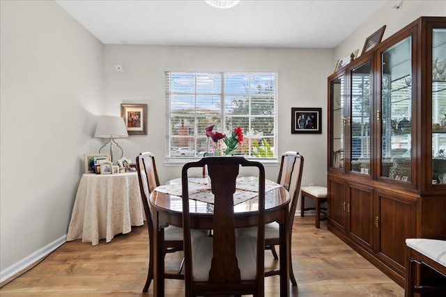 dining space featuring a healthy amount of sunlight and light wood-type flooring