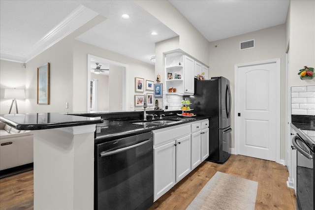 kitchen featuring white cabinets, tasteful backsplash, stainless steel dishwasher, and sink