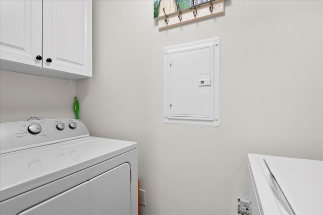 laundry room featuring cabinets, independent washer and dryer, and electric panel