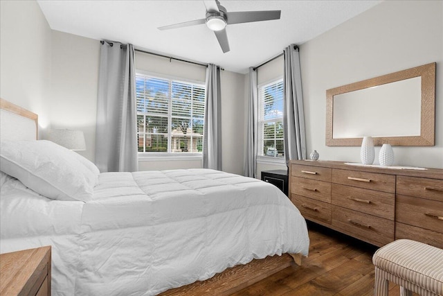 bedroom featuring ceiling fan and dark wood-type flooring