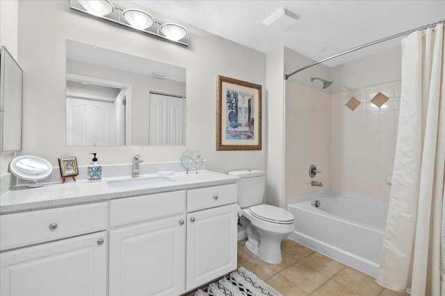 full bathroom with tile patterned floors, vanity, a textured ceiling, shower / tub combo with curtain, and toilet