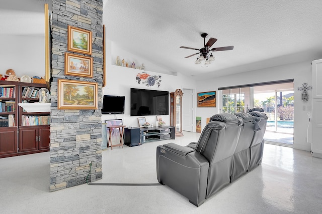 living room featuring lofted ceiling, ceiling fan, and a textured ceiling