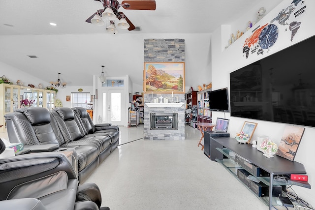 living room featuring a stone fireplace and ceiling fan