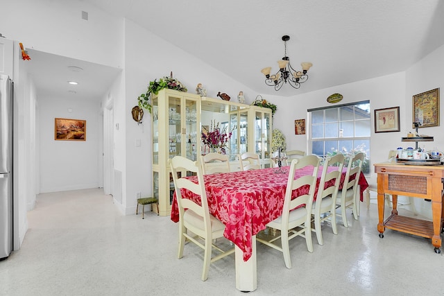 dining area with an inviting chandelier