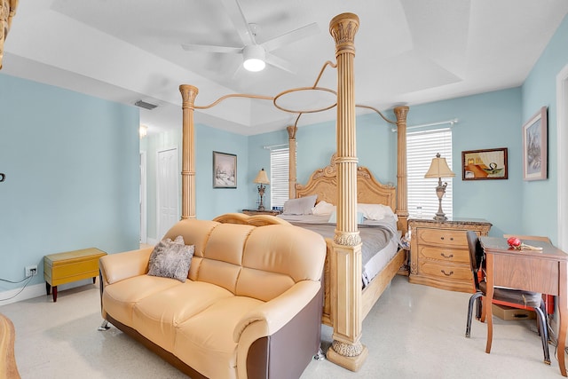 carpeted bedroom featuring a raised ceiling and ceiling fan