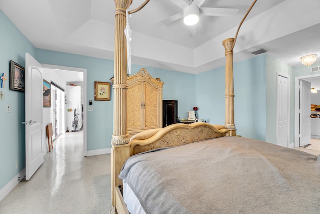 bedroom with a closet, a raised ceiling, and ceiling fan