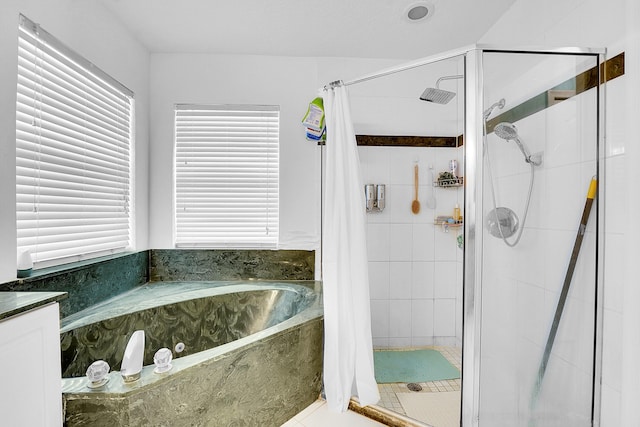 bathroom featuring plus walk in shower and tile patterned floors