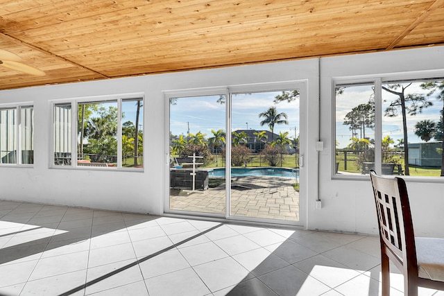 doorway to outside with light tile patterned flooring and wood ceiling