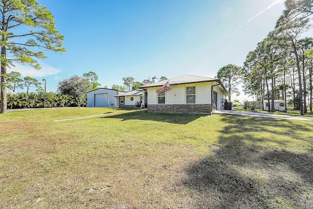 view of front of home with a front yard and a garage