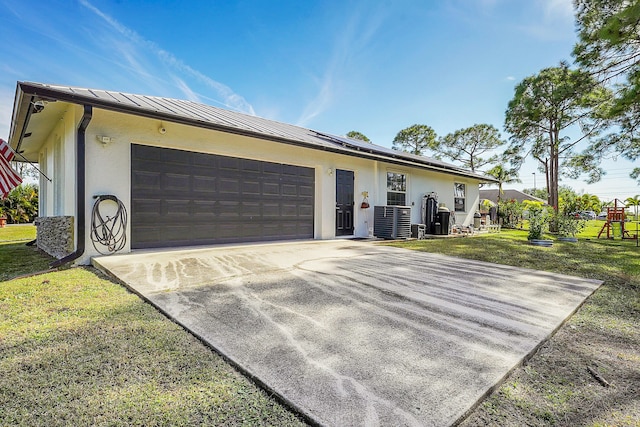 single story home with a garage and a front lawn