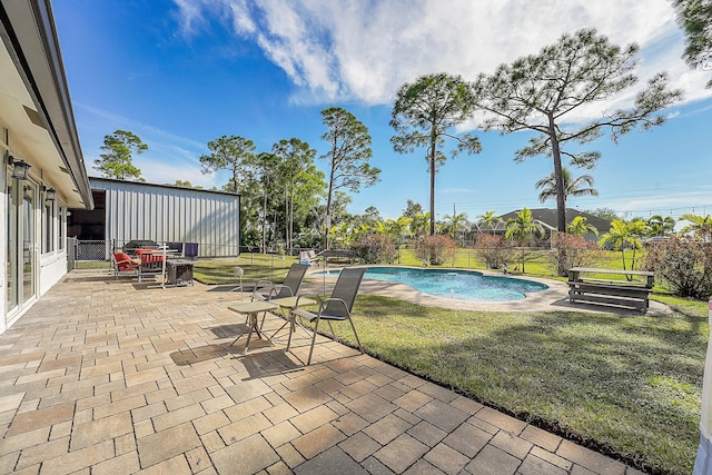 view of swimming pool with a lawn and a patio area