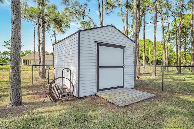 view of outbuilding with a yard