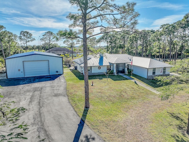 ranch-style house with a front lawn, an outdoor structure, and a garage