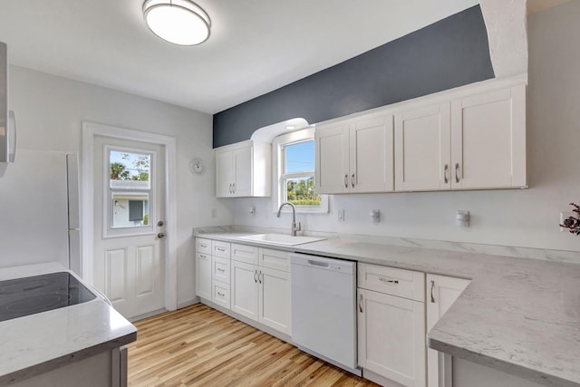 kitchen featuring white appliances, light hardwood / wood-style flooring, white cabinetry, and sink