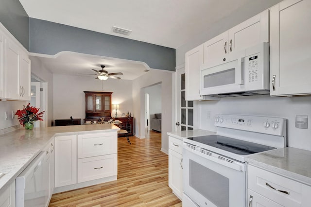 kitchen featuring white cabinets, white appliances, and kitchen peninsula