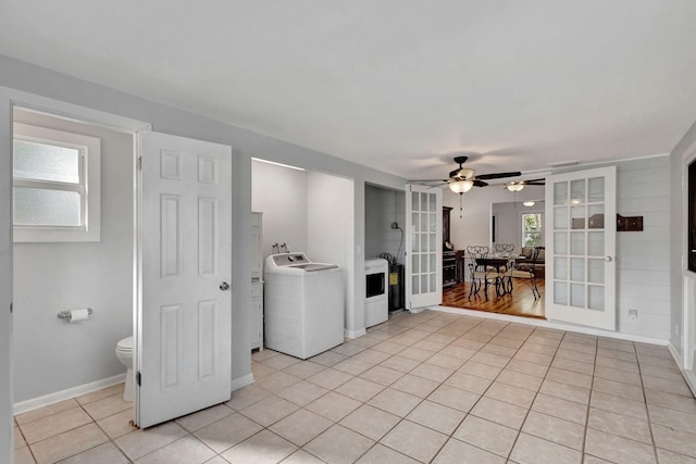 laundry area featuring washer / clothes dryer, ceiling fan, french doors, and light tile patterned floors