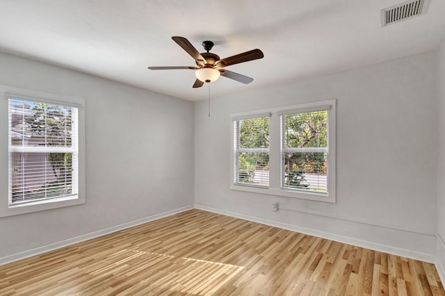 empty room featuring ceiling fan and light hardwood / wood-style flooring