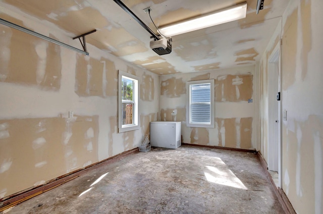 garage featuring refrigerator and a garage door opener