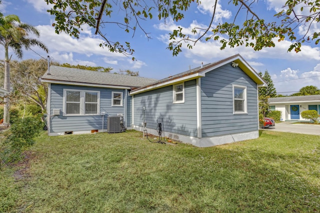 view of home's exterior with a yard and central AC unit