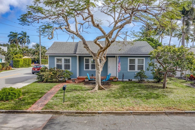 bungalow-style house with a front yard