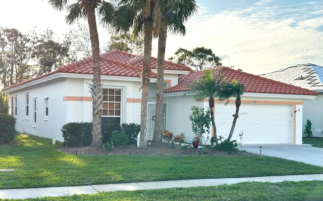 mediterranean / spanish home featuring a garage and a front lawn