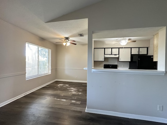 kitchen featuring white cabinetry, dark hardwood / wood-style flooring, kitchen peninsula, vaulted ceiling, and black appliances