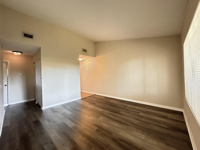 empty room with dark wood-type flooring