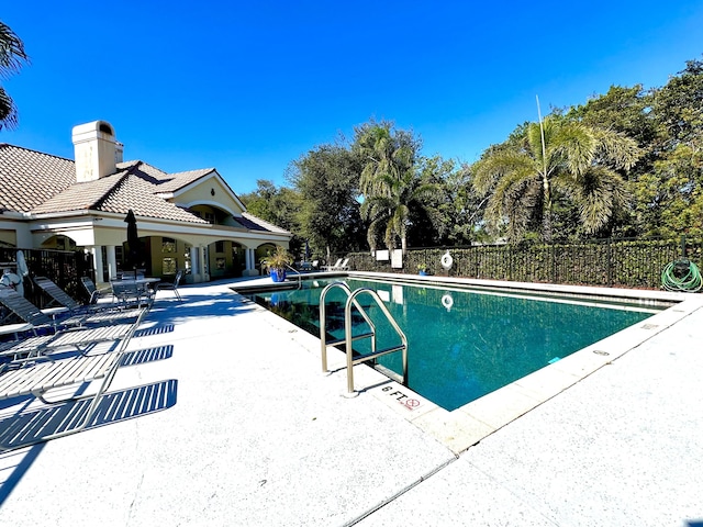 view of swimming pool with a patio area