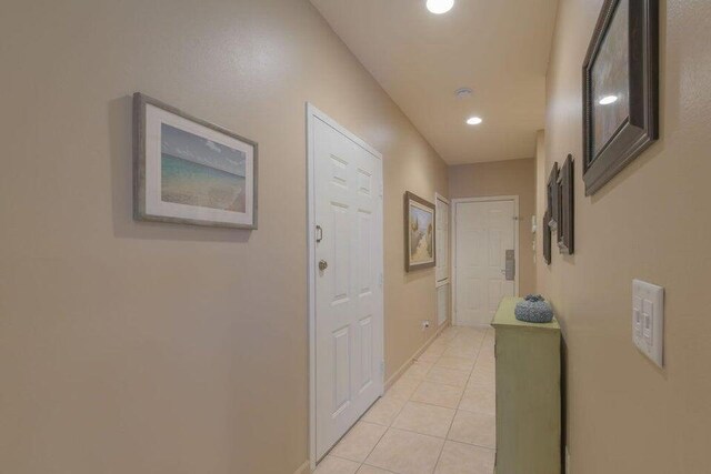 bedroom with light colored carpet, a raised ceiling, and ceiling fan