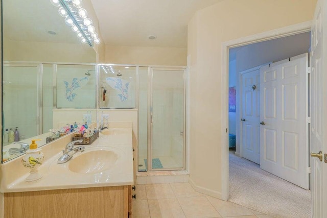 bathroom featuring vanity, tile patterned floors, and a shower with shower door