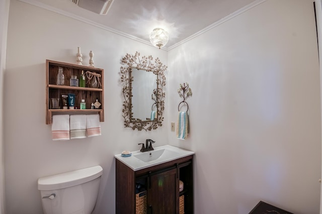 bathroom with vanity, toilet, and ornamental molding