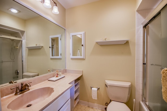 full bathroom with tile patterned flooring, vanity, toilet, and bath / shower combo with glass door