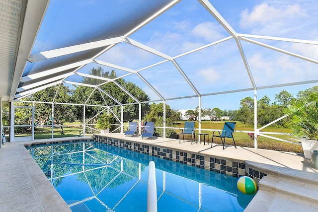 view of swimming pool featuring a patio area, glass enclosure, and a lawn