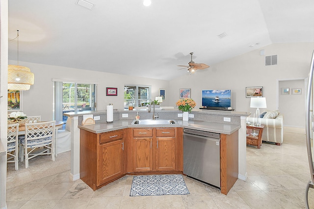 kitchen with vaulted ceiling, decorative light fixtures, dishwasher, an island with sink, and sink