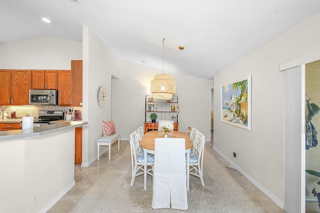 dining space with vaulted ceiling