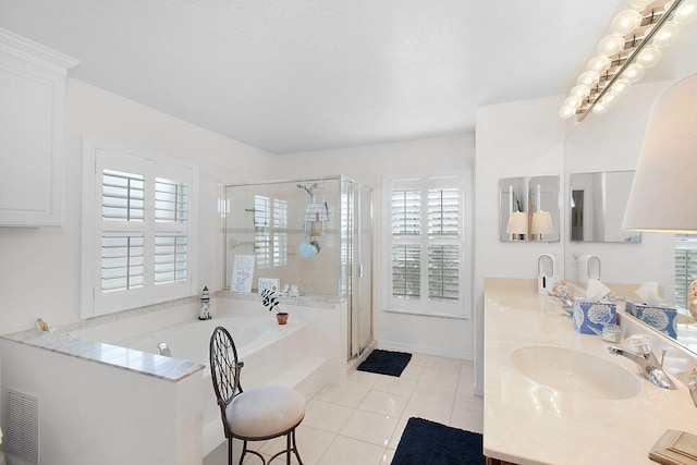 bathroom with vanity, tile patterned floors, and shower with separate bathtub