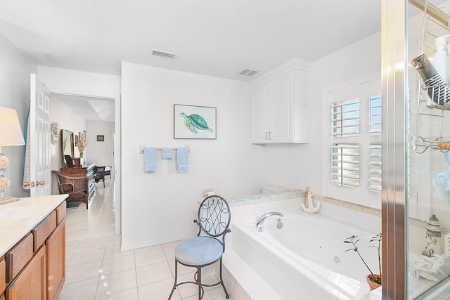 bathroom featuring tile patterned flooring, vanity, shower with separate bathtub, and a textured ceiling