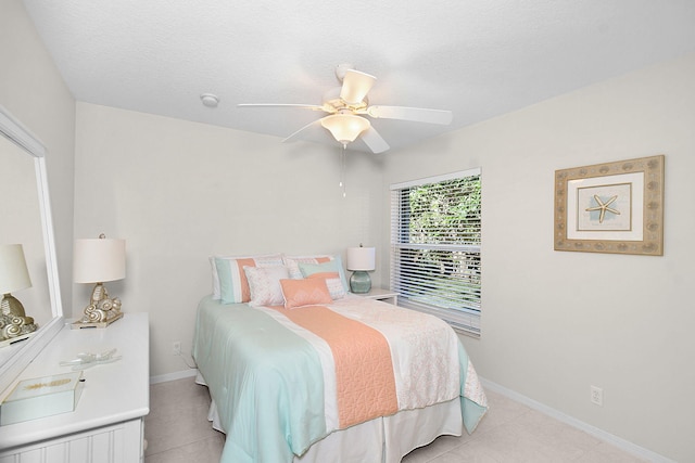 tiled bedroom featuring ceiling fan